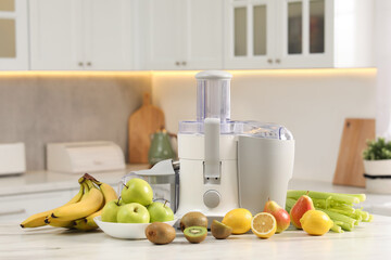 Wall Mural - Modern juicer and fruits on white marble table in kitchen