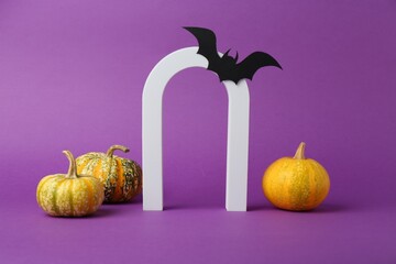 Wall Mural - Presentation of product. Arc and Halloween decor on purple background, space for text