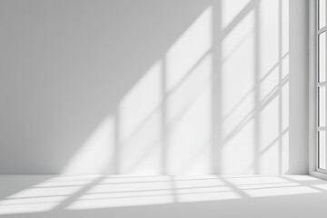 A white room with light shining through a window and creating shadows on the floor.