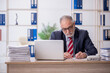 © Elnur - Old male employee and too much work in the office