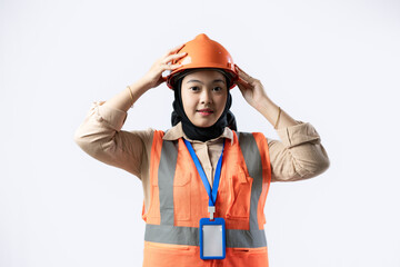 Young Asian female construction worker wearing hijab wearing construction safety helmet, industrial and construction concept, isolated on white background.