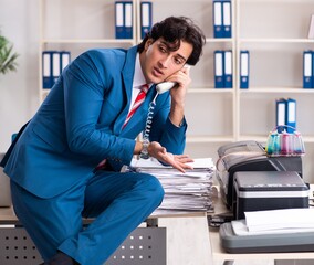 Wall Mural - Young employee making copies at copying machine