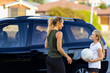 © Austockphoto - mother and child near car going to netball training