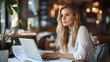 © pkproject - Businesswoman Prepares for Presentation at Desk with Laptop and Documents