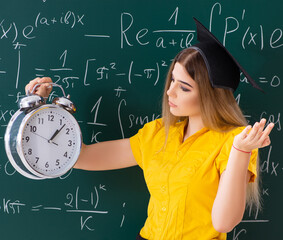 Wall Mural - Young female student in front of the chalkboard