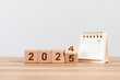 © Deemerwha studio - Flipping wooden cube from 2024 to 2025. Happy new year Calendar 2025. New year resolution, goal, plan, and action concept. target plan and mission annual. background and banner
