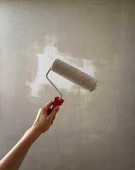 Roller Brush Painting, Worker painting on surface wall Painting apartment, renovating with white color paint. Leave empty copy space to write descriptive text beside.