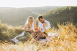 © anatoliycherkas - Happy Family Enjoying a Sunny Picnic in the Beautiful Countryside