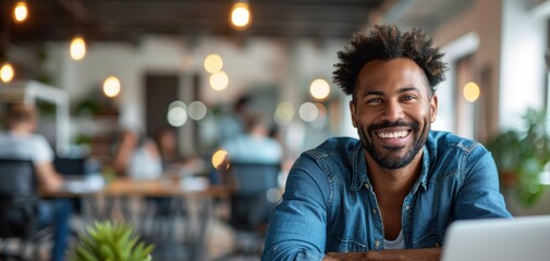 Wall Mural - A man smiles at the camera while sitting at his desk. AI.