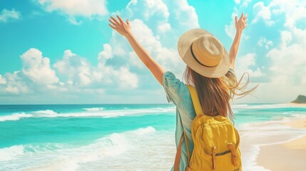 Wall Mural - Happy woman with hat and backpack standing on beach with arms raised.