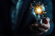 © oksa_studio - Businessman holding light bulb shining with network connection inside concept for idea innovation and inspiration