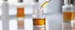 © ImagePulse - A pipette extracting liquid from a vial for testing the formula s efficacy in cosmetic development