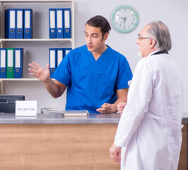 Sticker - Two doctors talking at the reception in hospital