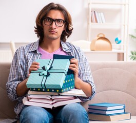 Wall Mural - Young male student preparing for exams during Christmas