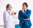 © Elnur - Young businessman meeting with old doctor