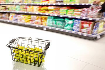 Wall Mural - Juicy grapes in a basket on the background of shelves with products, macro, isolated on white background..