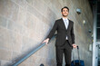 © Minerva Studio - Confident businessman with luggage at airport