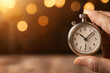 © Weerapat - Closeup of a hand adjusting a stopwatch on a clutterfree desk, representing the balance of time management and efficiency