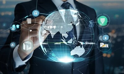 Businessman holding digital globe with global network and internet technology icons and big data connections on dark background