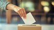 © Nicat - Voting concept showing hand dropping a ballot into a box, representing citizen participation in elections.
