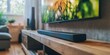 © Kamonwan - Modern living room featuring a sleek soundbar and vibrant TV display, creating a cozy entertainment space.