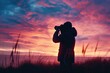 © Fotograf - A person holding a camera and capturing the beauty of a sunset