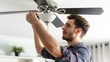 © Imsuniyah - Man Fixing a Ceiling Fan