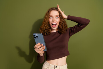 Sticker - Photo of shocked impressed girl wear brown shirt getting emails modern gadget empty space isolated khaki color background