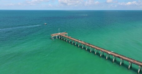 Canvas Print - People enjoying vacation time on Venice fishing pier in Florida. Seaside summer activities on fresh air