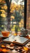 © AlexCaelus - Steaming cup of tea and coffee, open notebook with pen on fall leaves background, cozy autumn scene by the window.