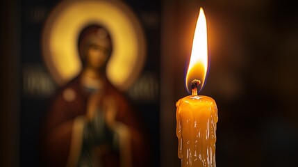 A single candle, lit in front of an icon of the revered Saint Mary and Theotokos, concept of orthodox holidays, prayer, religious sacrament, God's help, prayer to the Virgin Mary