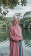 © PixelQraze - Woman in Pink Hijab Posing by a Tranquil Pond in a Park