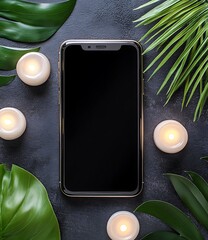 Wall Mural - Black Smartphone Screen with Green Leaves and Candles on a Grey Surface