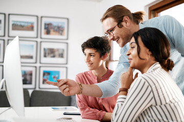 Wall Mural - Business, people and happy with pointing on computer at office for deadline or task competition. Employees, coworking and meeting with smile for teaching, learning and advice with software update