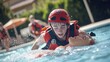 © Suphawan - A lifeguard trainee practicing rescue techniques on a water-specific training dummy at a poolside.