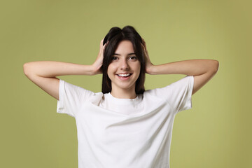 Poster - Portrait of cute teenage girl on olive background