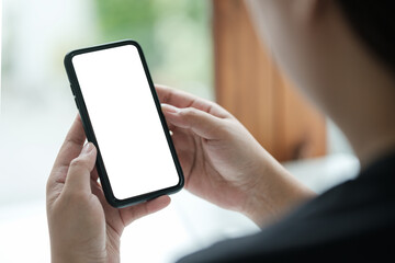 Wall Mural - close up shot of man holding a smartphone with a blank white screen, for mockups or showcasing mobil