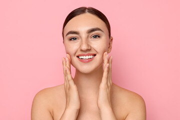 Sticker - Face massage. Beautiful young woman with healthy skin on pink background