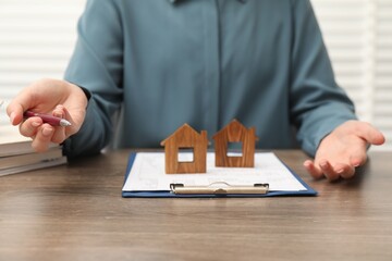 Wall Mural - Real estate agent working at wooden table, closeup