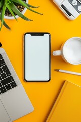 Wall Mural - Top View of a Yellow Desk with a Laptop, Smartphone, and a Coffee Cup