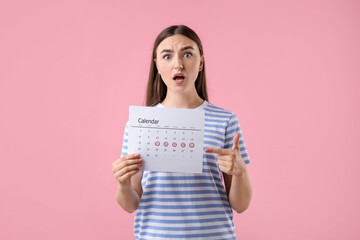 Poster - Emotional woman holding calendar with marked menstrual cycle days on pink background