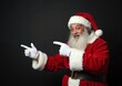 © Yury - Santa Claus with Cheerful Smile Pointing Both Ways Against Dark Background