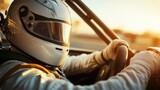A racer in a white helmet grips the steering wheel as the sun sets behind them.