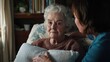 © keetazalay - An elderly woman receiving gentle care at home, with a nurse adjusting her pillows while discussing wellness plans