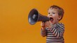 © Johannes - Young toddler boy happily screaming in megaphone loudspeaker on studio orange background. Important announcement news, significant messages sale discount concept. Copy paste place for text