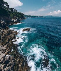 Canvas Print - Aerial View of Rocky Coastline with Blue Ocean Water