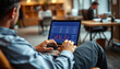 © Jacks Studio - Man using laptop to analyze stock market statistics in modern workspace