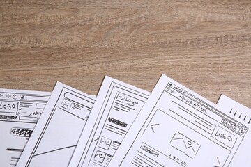 Wall Mural - developing ui design. sketches of website wireframes on wooden table, top view