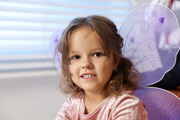 Wall Mural - Cute girl dressed like fairy indoors. Halloween costume