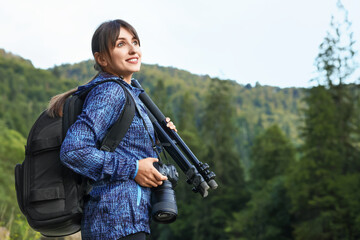 Poster - Photographer with backpack, camera and other professional equipment outdoors. Space for text